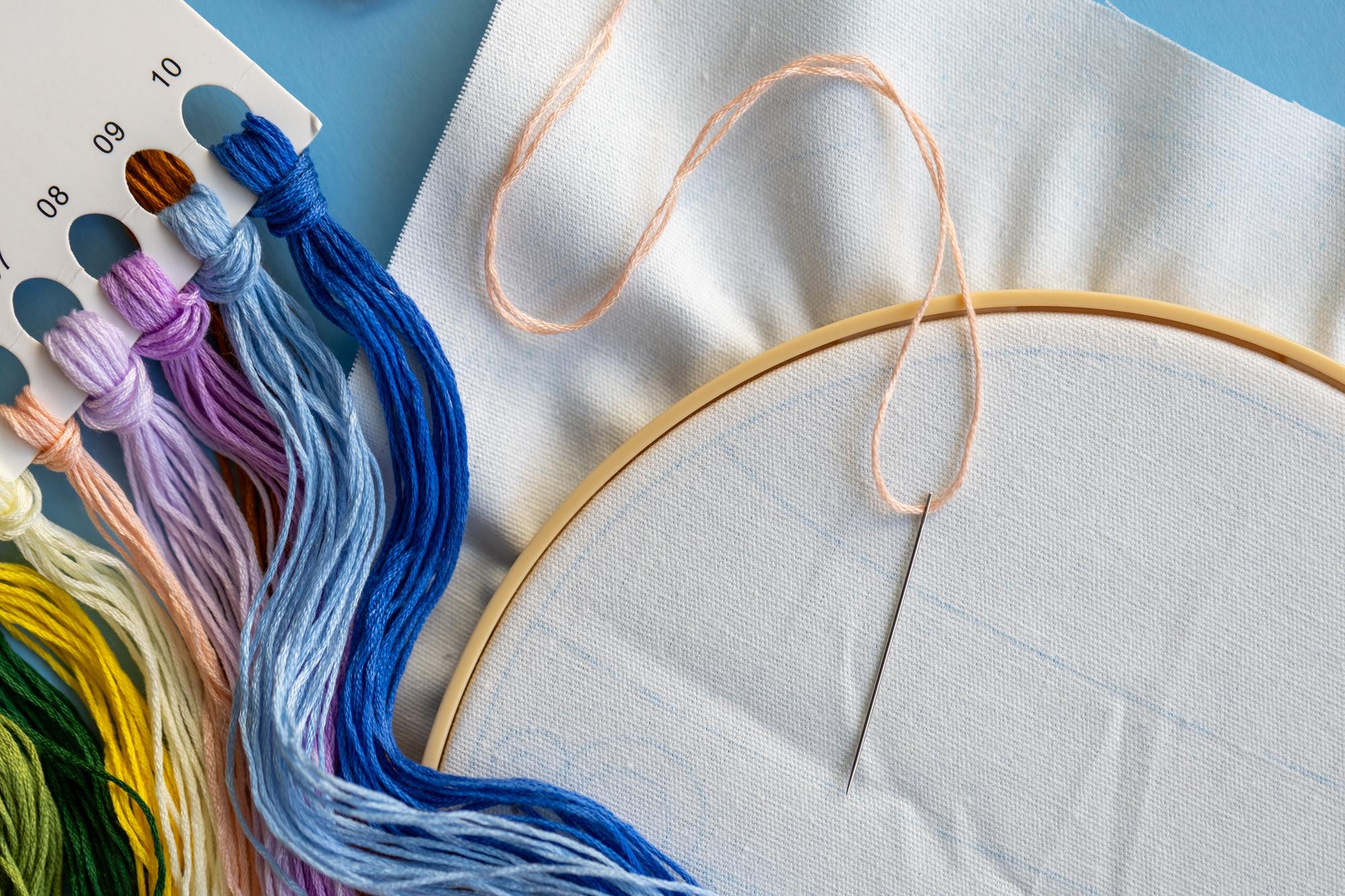 Three embroidered samples on paper background